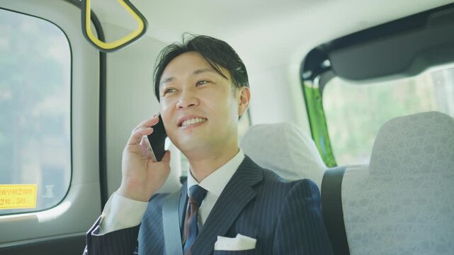 Businessman on a business call while riding in a taxi