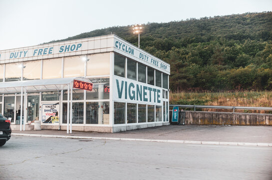 KULATA, BULGARIA &ndash; AUGUST 15, 2026: Vignette sales point near the Bulgaria-Greece border crossing in Kulata, with a duty-free shop and vehicles visible nearby.