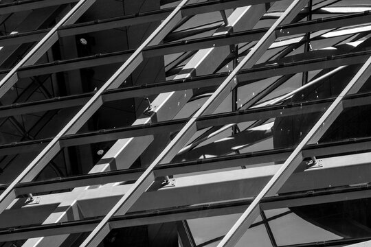 Abstract black and white facade with diagonal lines and shadows creates a graphic urban architectural detail full of rhythm and geometry