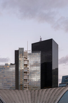 Office towers in La Defense Paris France rise beneath a cloudy evening sky showing modern business architecture and dense urban development