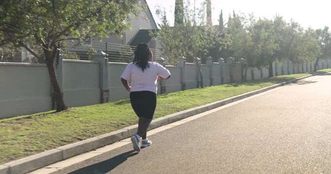 Lifestyle videos outdoor of people doing activities, running on sidewalk, woman in athletic wear exe