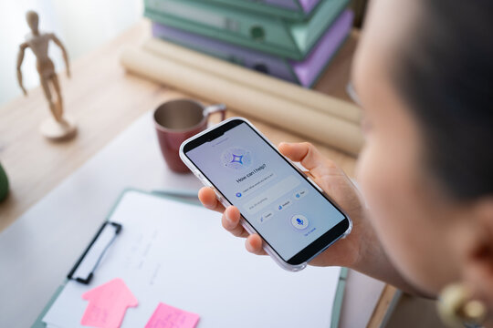 White person holding smartphone with voice assistant app