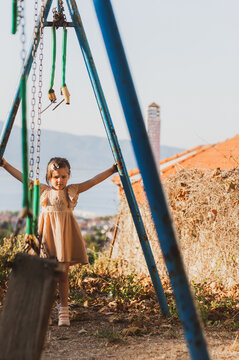 Little Girl Alone at an Abandoned and Neglected Playground