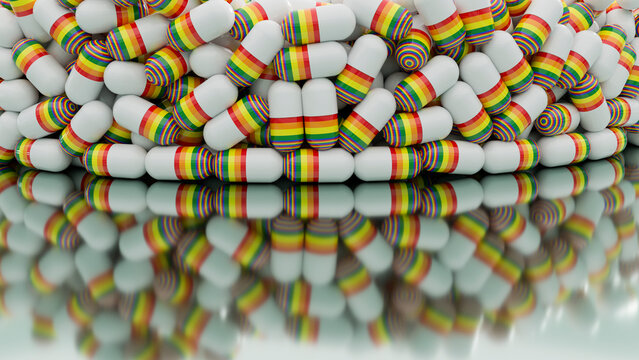 Capsules with rainbow stripes stacked reflecting on glossy surface