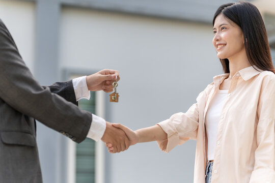 lease, rental and selling home. Real estate agent manager smile holding key for new owner. rent house, Sales, loan credit financial, insurance, Seller, dealer, installment,  buy, sell, move in