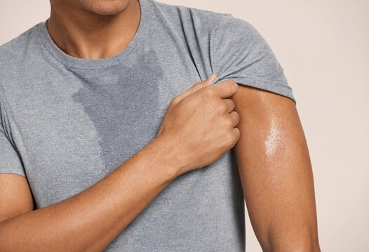 Young man experiencing excessive sweating and underarm perspiration issues