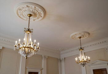 Obraz premium Luxury interior design and classic architecture, elegant crystal chandeliers hanging from ornate ceiling medallions in a historic mansion ballroom