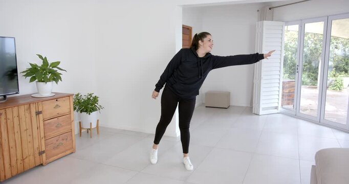 High speed photography for dynamic scenes, indoors, woman stretching arm in living room, staying act