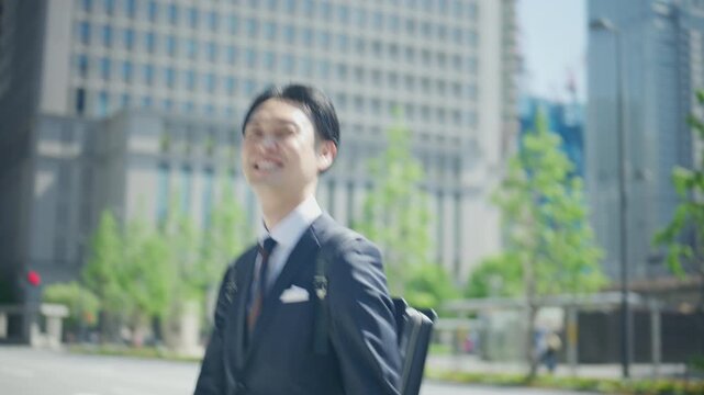 Japanese businessman walking to work between office buildings