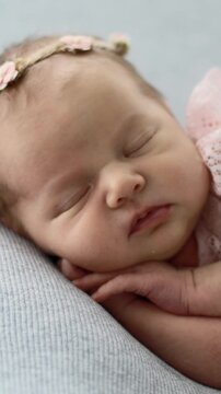 Newborn Baby Girl In A Pink Dress Sleeping During A Photoshoot In A Vertical Video