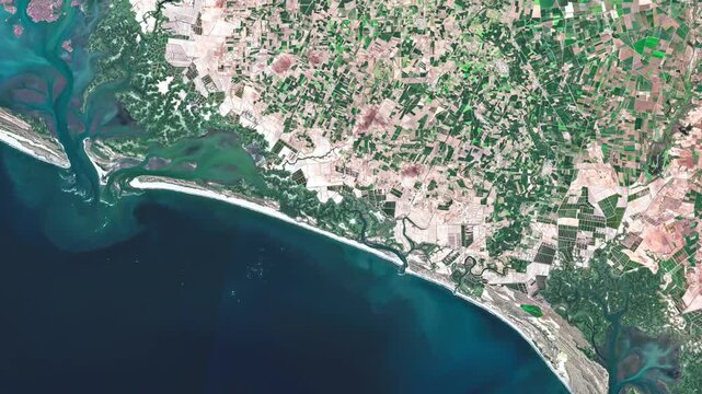 Aerial view of the Pacific coast of Sinaloa, Mexico, showing agricultural fields, coastal plains and the transition between farmland and the sea.