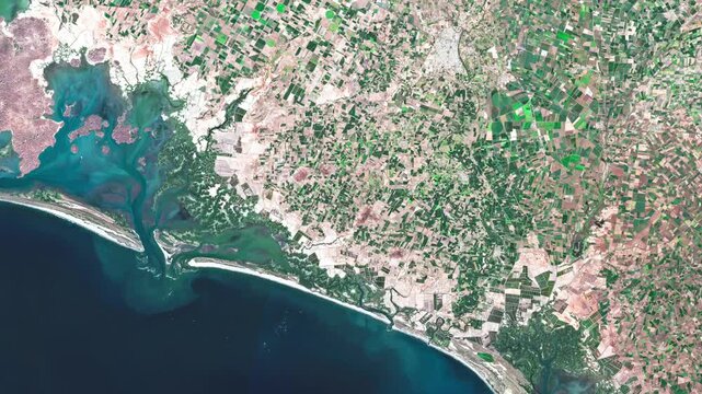 Aerial view of the Pacific coast of Sinaloa, Mexico, showing agricultural fields, coastal plains and the transition between farmland and the sea.