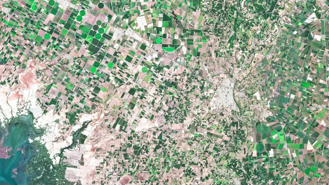 Aerial footage of agricultural land along the Pacific coast in Sinaloa, Mexico, highlighting cultivated fields and the coastal agricultural landscape