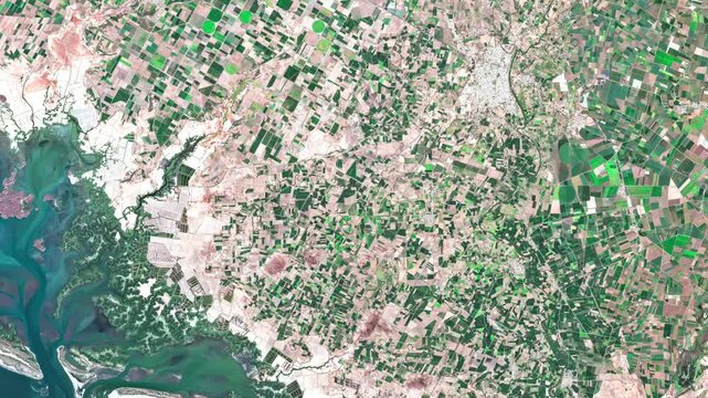 Aerial footage of agricultural land along the Pacific coast in Sinaloa, Mexico, highlighting cultivated fields and the coastal agricultural landscape