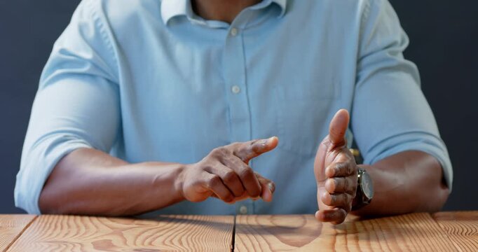 Close up of people talking to the camera, businessman in blue shirt making point with raised finger
