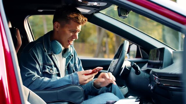 Young man sitting in car reacts to bad odor from conditioner in city street with disgust and discomfort. Adult guy tourist feels unpleasant smell outdoors while checking cooling system inside vehicle.
