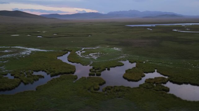 Aerial view of Song Kol Lake wetlands at twilight, Kyrgyzstan.