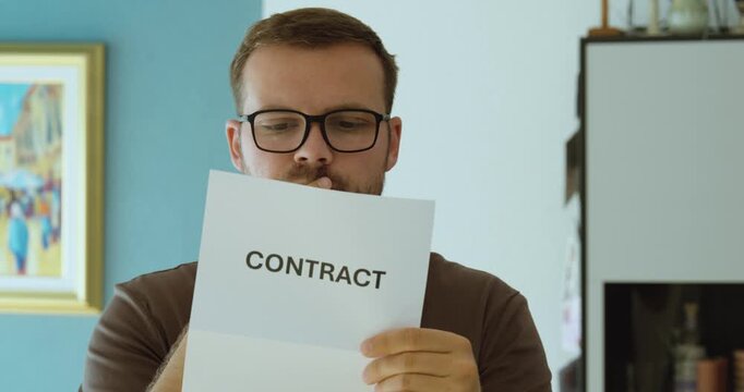 Serious man reading a contract document, representing legal agreement, business terms, obligations and contract review.