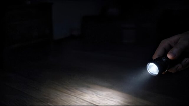A person holding a flashlight in their hand, ready for adventure or navigation