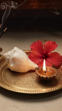 Hindu Puja Thali with Lit Diya Hibiscus and Conch Shell Vertical