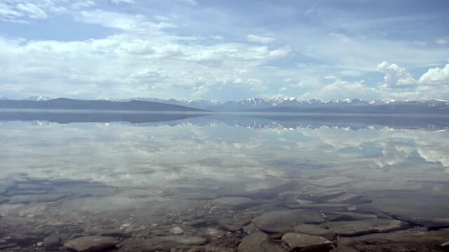 Shallow Water Over Layered Stones in Freshwater Lakeshore Landscape. The shot keeps the main subject and surrounding underwater context visible.