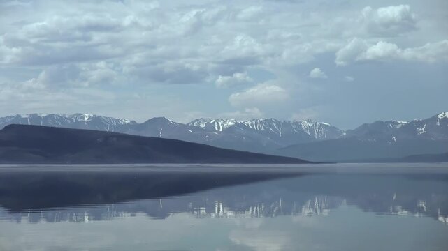 Calm Lake and Snow Patched Mountains in Freshwater Shoreline Landscape. The composition preserves the subject, nearby surfaces and spatial context.