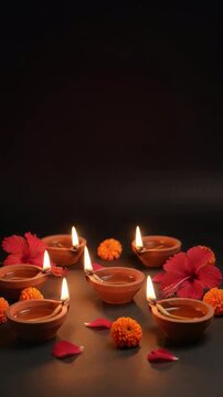Burning Diya Lamps with Hibiscus Flowers for Kali Puja Celebration