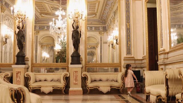 A Young Girl Walking Inside The Ornate Ballroom Of The Palace Of The Marques de Dos Aguas In Valencia, Spain. Static Shot