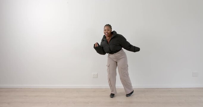 High speed photography for dynamic scenes, Dancing joyfully, woman in casual outfit enjoying her tim