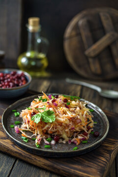 Fermented cabbage salad served on rustic plate with fresh herbs