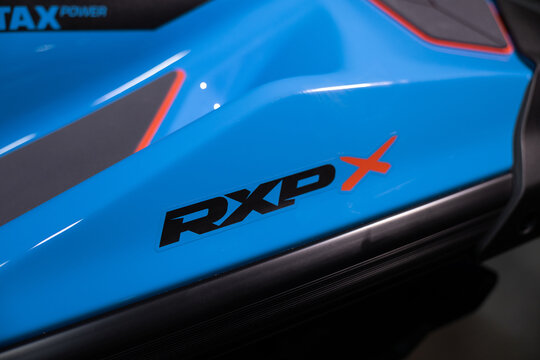 A sleek, high-performance blue Sea-Doo jet ski on a pitch-black studio background. Sharp body lines, glossy finish, dramatic rim lighting. Professional product photography, premium marine vehicle