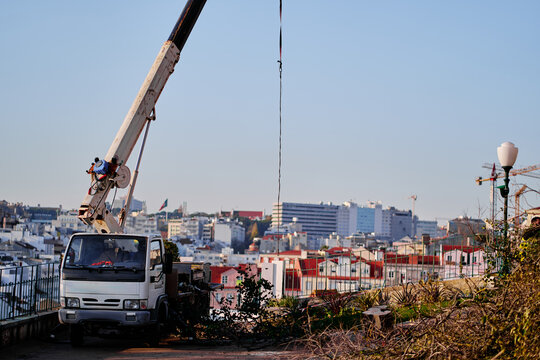 Construction Crane Truck Operating in Urban Cityscape Environment