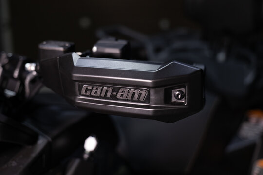 A rugged, aggressive black BRP Outlander ATV isolated on a solid black background. Powerful stance, mud-terrain tires, and detailed off-road design. Sharp studio lighting highlights the metallic frame