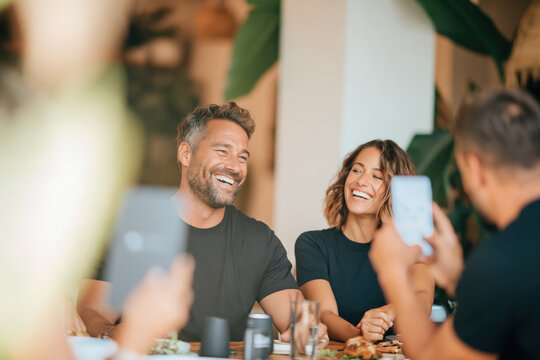 Friends laughing during brunch in a modern restaurant