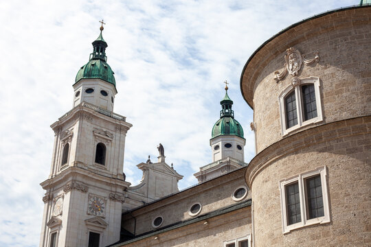 Green Copper Dome and Apse of Salzburg Cathedral against Blue Sky with Clouds in Salzburg, Austria.