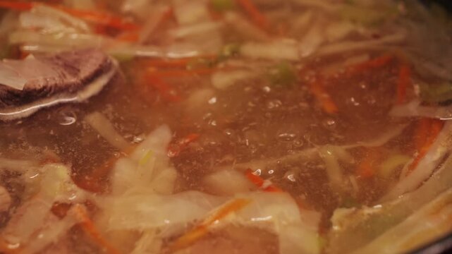 Homemade Shchi soup with chopped white cabbage cooked in bone broth, tasty soup close up. High quality 4k footage