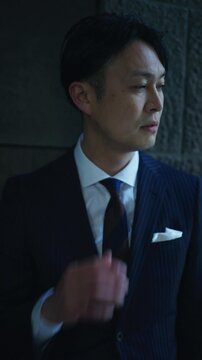 Stressed businessman holding his neck and looking down in the shade