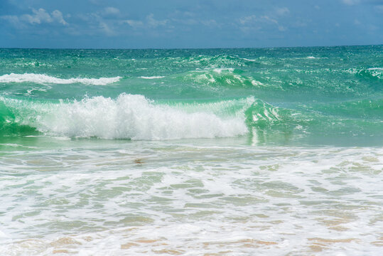 Turquoise ocean sea water. Tropical sea beach in summer seaside outdoor. Blue sea marine ocean seascape tropical huge wave on blurred background. Seascape dark ocean background wave splash on rock
