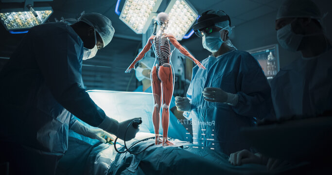 Futuristic Hospital Operating Room Surgery Using Holographic Augmented Reality. Surgeon in AR Headset Scales Muscular and Skeletal Hologram With Bare Hands While the Team Performs Hip Treatment.