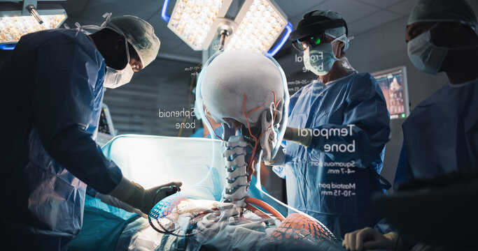 Futuristic Hospital Operating Room Surgery Using Holographic Augmented Reality. Surgeon in an Ar Headset Rotates a Glowing Skull and Spine Hologram With Labeled Bones While the Team Cures a Patient.