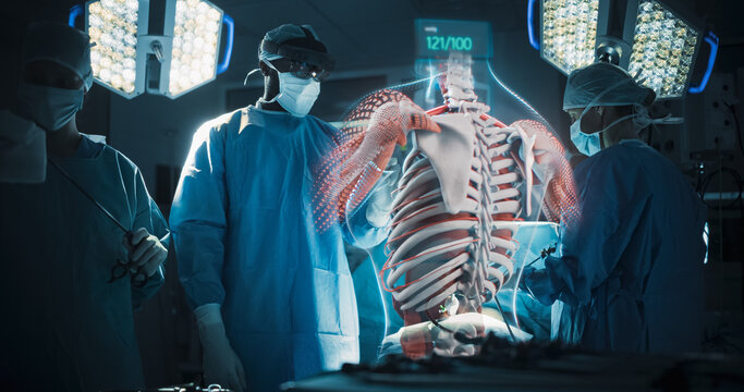 Futuristic Hospital Operating Room Surgery Using Holographic Augmented Reality. Surgeon in an Ar Headset Rotates a Glowing Hologram of a Human Ribcage and Spine for Bone Tumor Surgery.