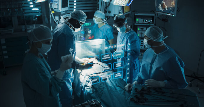 Futuristic Hospital Operating Room Surgery Using Holographic Augmented Reality. Surgeon in an Ar Headset Navigates Floating Vital Signs and Heart Scan Panels While the Team Performs Keyhole Treatment.