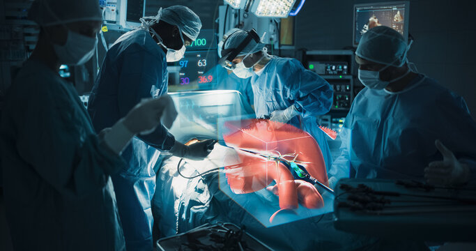 Futuristic Hospital Operating Room Surgery Using Holographic Augmented Reality. Surgical Team in Ar Headsets Studies Liver Hologram and Vital Signs While Guiding Instruments During Treatment.