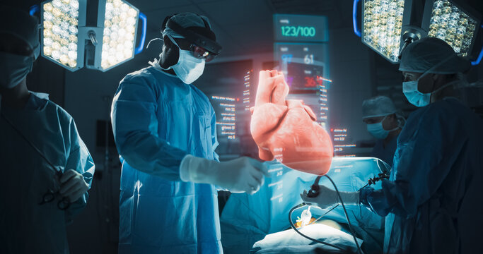 Futuristic Hospital Operating Room Surgery Using Holographic Augmented Reality. Surgeon in Ar Headset Treats Holographic Heart With Live Vitals as the Surgical Team Performs Invasive Treatment.