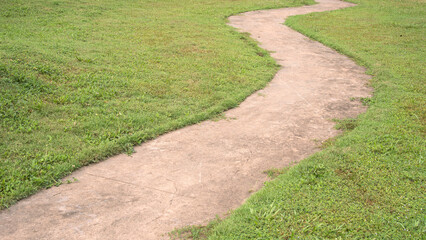 Obraz premium Winding Concrete Walkway Path Through Green Lawn Landscape Park Garden Pathway S Curve High Angle