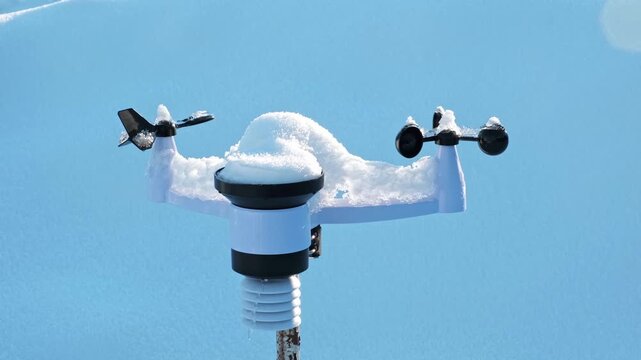 Wireless weather station on pole in snow. Sensors of temperature and humidity, Rain gauge and snow, Wind speed and direction. Climate monitoring, atmospheric research, Meteorological equipment. 4K.