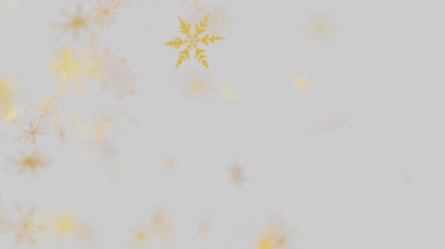Golden snowflakes falling on a light gray festive background