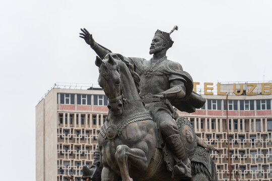 Amir Timur statue close-up with Hotel Uzbekistan in the background, gray weather, Tashkent