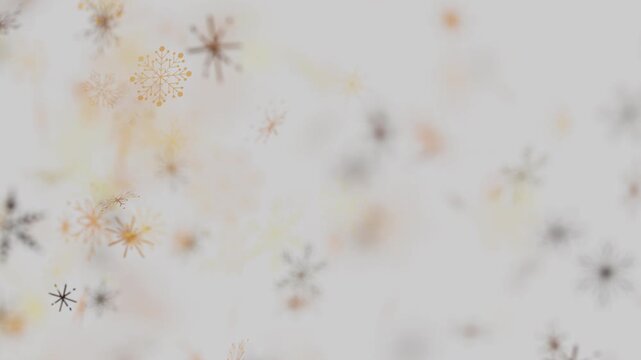Abstract winter background with blurry warm colored snowflakes