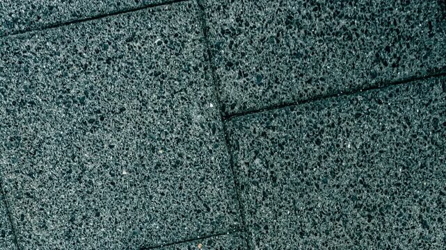 Textured ground pattern with square tiles
